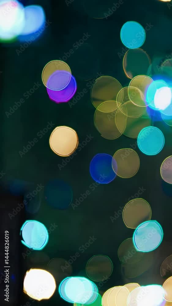 Poster blurred bokeh lights in vibrant colors create a dreamy, abstract video effect. shot from a low angle