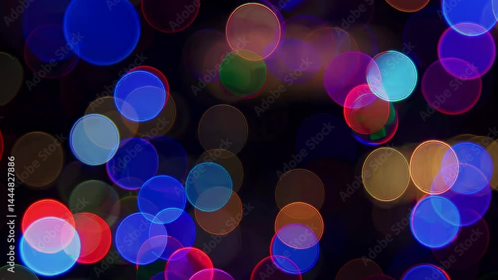 Poster colorful bokeh lights create an abstract, dreamy effect. the video captures this from a top-down ang