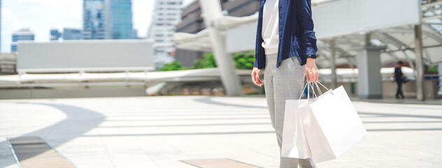 Adult business woman standing hand holding shopping bag background with copy space