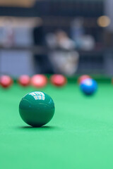 A close-up of the green ball on the snooker table.