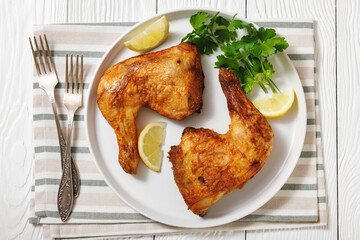 roast chicken legs with crispy skin on a plate