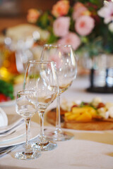 Elegant dining with fine glassware and a floral backdrop