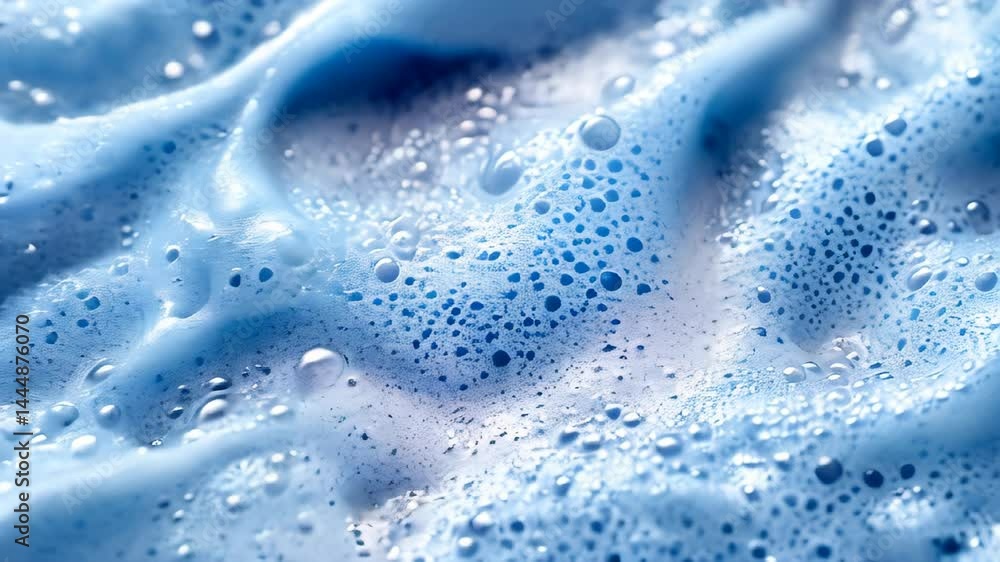 Poster close-up view showcases vibrant blue foam with intricate bubbles formed in water play. the mesmerizi