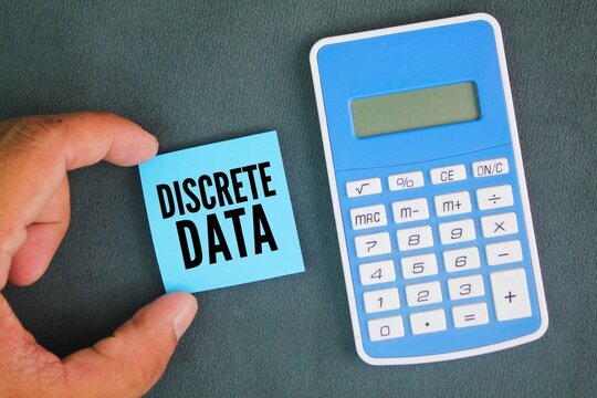 calculator and colored paper with the word Discrete Data. a type of quantitative data that includes non-divisible figures and statistics you can count - Powered by Adobe