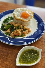 Stir fried prawn with bird’s eye chilies with streamed rice serving on blue plate