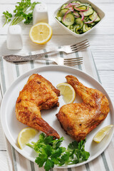roast chicken legs with crispy skin on a plate