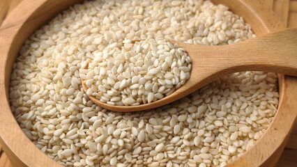 White sesame seeds in a wooden spoon