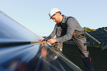 Worker installing solar panels outdoors