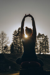 Fit sporty happy young woman wearing sportswear meditating doing yoga breathing stretching...