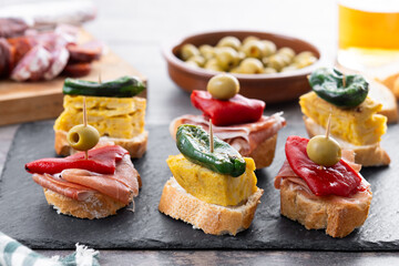 Traditional Spanish pintxos on wooden table
