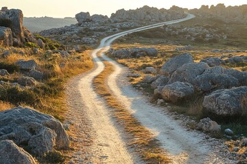 Scenic Winding Gravel Path Through Rocky Landscape With Warm Sunlight & Boulders