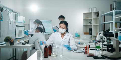 Medical science and technology professionals working in a laboratory research environment where scientists conduct chemistry tests and medical experiments to improve global healthcare