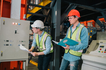 Engineers inspect industrial control systems ensuring safety efficiency and precision in a modern manufacturing environment with teamwork and technical expertise driving operational excellence