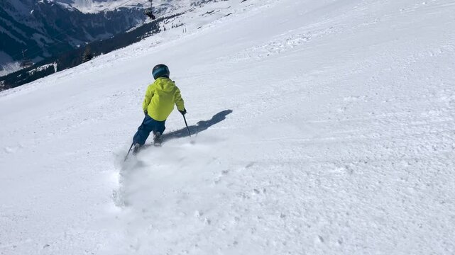 Happy family with children, school kids in winter ski resort, skiing winter time