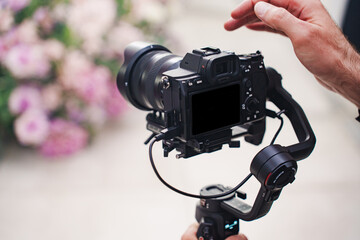 Capturing moments with a camera and gimbal at a floral event