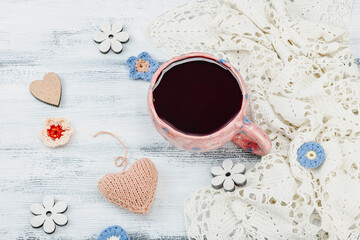 A cup of fragrant hibiscus tea and cute handmade decor. Good mood concept, cozy home comfort