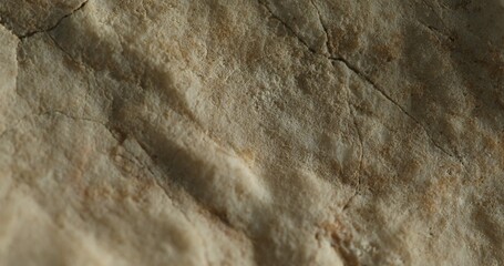 Close-up shot of cracked sandstone surface with natural earthy tones