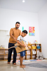 Fototapeta premium Middle Eastern Man And Little Boy in a Cardboard Plane