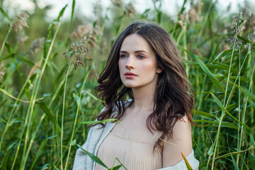 Fototapeta premium Glorious spring woman walking outdoors on nature background, fashion beauty portrait