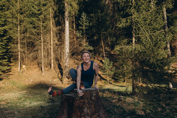 Fit sporty happy young woman wearing sportswear meditating doing yoga breathing stretching...