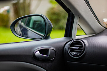 Interior of a car with a black interior and daylight outside