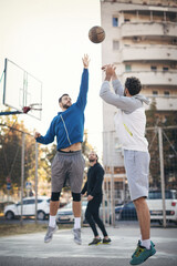 Group of friends playing basketball outdoors
