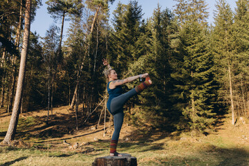 Fit sporty happy young woman wearing sportswear meditating doing yoga breathing stretching...