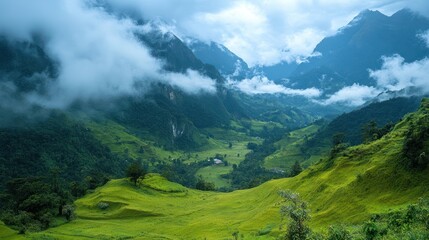 Fototapeta premium Verdant valley shrouded in clouds, cascading hills in a mountain landscape