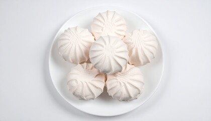 Marshmallows on a plate on a white background