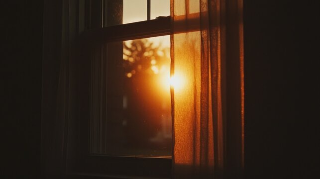 Bright sunlight streams through a window with a curtain