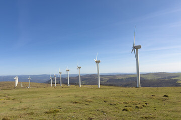 wind power plants against a blue sky on a bright sunny day