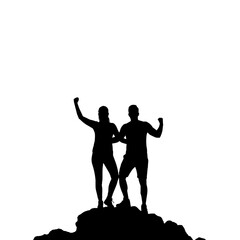 Obraz premium Silhouette of a Triumphant Couple Celebrating Success and Victory Together on a Mountain Summit with Raised Hands