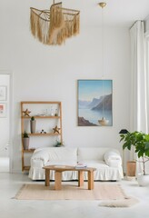 A white couch in a living room with a painting on the wall, a wooden shelf with decorations and a plant on a shelf 