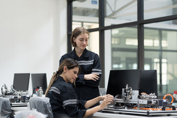 Assembling computer hardware. Engineer assembling circuit board in technology lab. Team engineer...