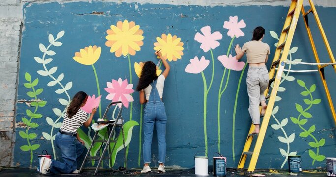 Wall art, women and painting mural outdoor for sustainable awareness, community project or creative teamwork. Flower decoration, people and floral inspiration for DIY public design, earth day or back
