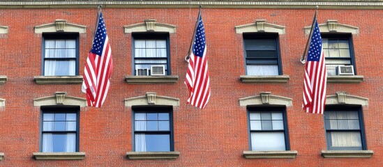Fototapeta premium Patriotic building facade with American flags adorning the window ledges