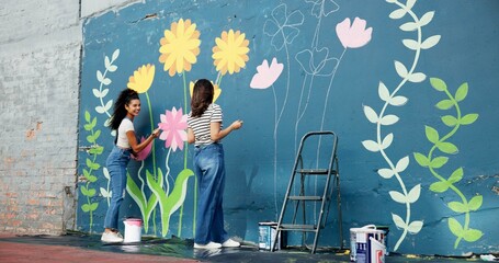Girls, painters or teamwork for wall for mural, drawing flowers or community service at building. Artist, talking or creative women with craft for floral decoration, renovation or project for design © CineLens25/peopleimages.com