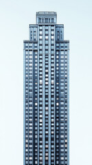 Fototapeta premium tall building with sleek design against light background, showcasing modern architecture