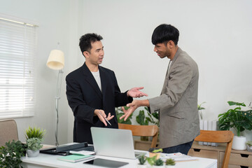 Professional Collaboration and Document Review. Two men discussing key points while reviewing...