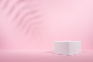 White square podium for display cosmetic and other products in sunlight on gradient pastel pink background, copy space