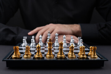 selective focus of chessboard player on blurred background