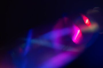 Colorful light leak on black background, abstract design with optical lens flare shot on a long lens
