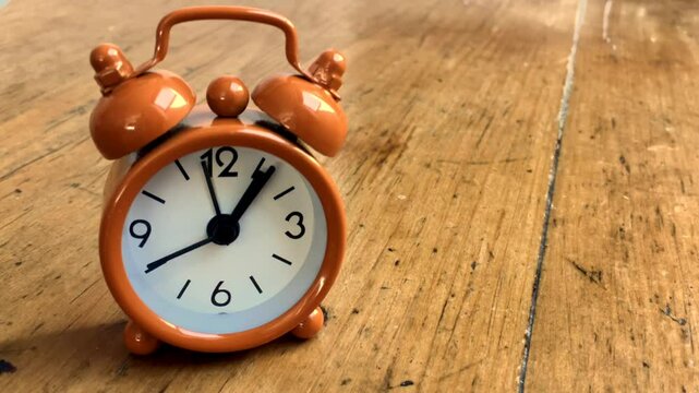 Alarm clock running backwards . Concept for turn back time 
