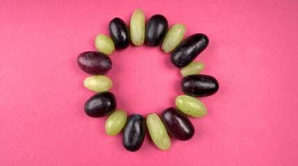 Natural organic juicy sliced of melon and watermelon with different types of grapes on a red background. Slices are on the table. top view, Agriculture concepts.