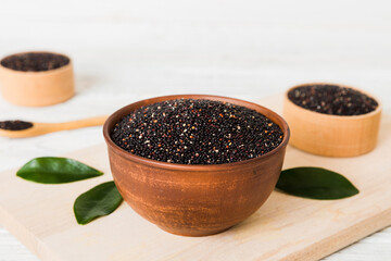 quinoa seeds in bowl and spoon on colored background. Healthy kinwa in small bowl. Healthy superfood