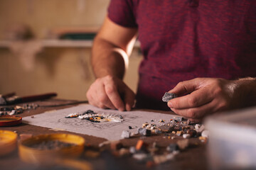 Closeup shots of man working on mosaic