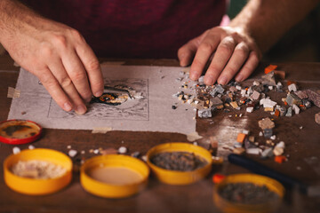 Closeup shots of man working on mosaic