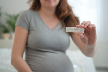 Expecting mother nervously viewing polymerase chain reaction results. Crucial infection screening...