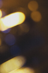 Gold yellow light abstract bokeh on black background.