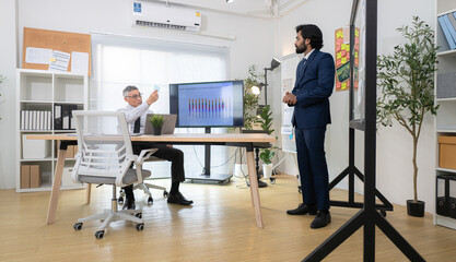 In a contemporary office, two senior executives with a mission to brainstorm and monitor the progress of a business project